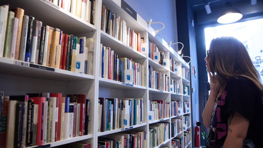 Mujer buscando un libro en la bibloteca