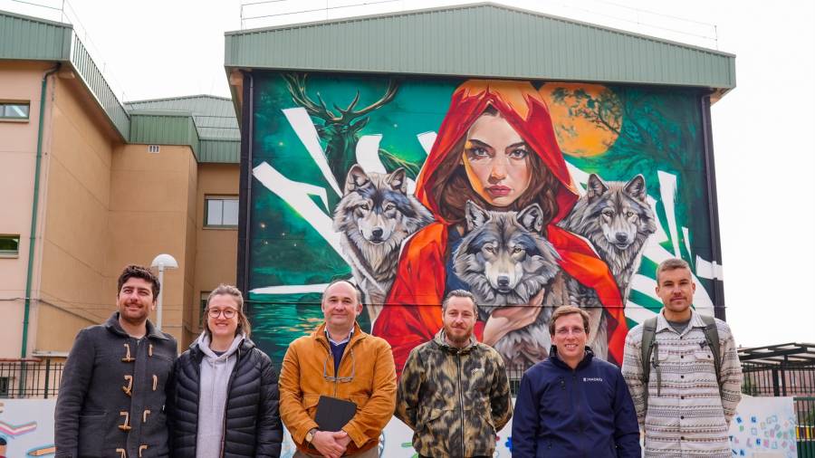 El alcalde de Madrid, José Luis Martínez-Almeida, y el concejal-presidente del distrito, Nacho Pezuela, posan con varios artistas de ‘Muraltalaz’ delante del mural Wolves family, de Asen Navarro